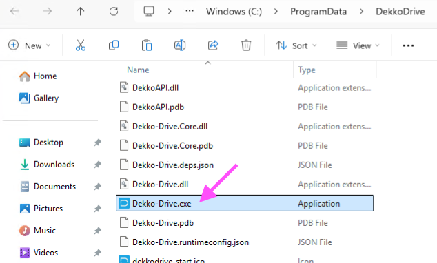Windows Explorer showing the DekkoDrive folder in C:\\ProgramData, with Dekko-Drive.exe selected and marked by a pink arrow.