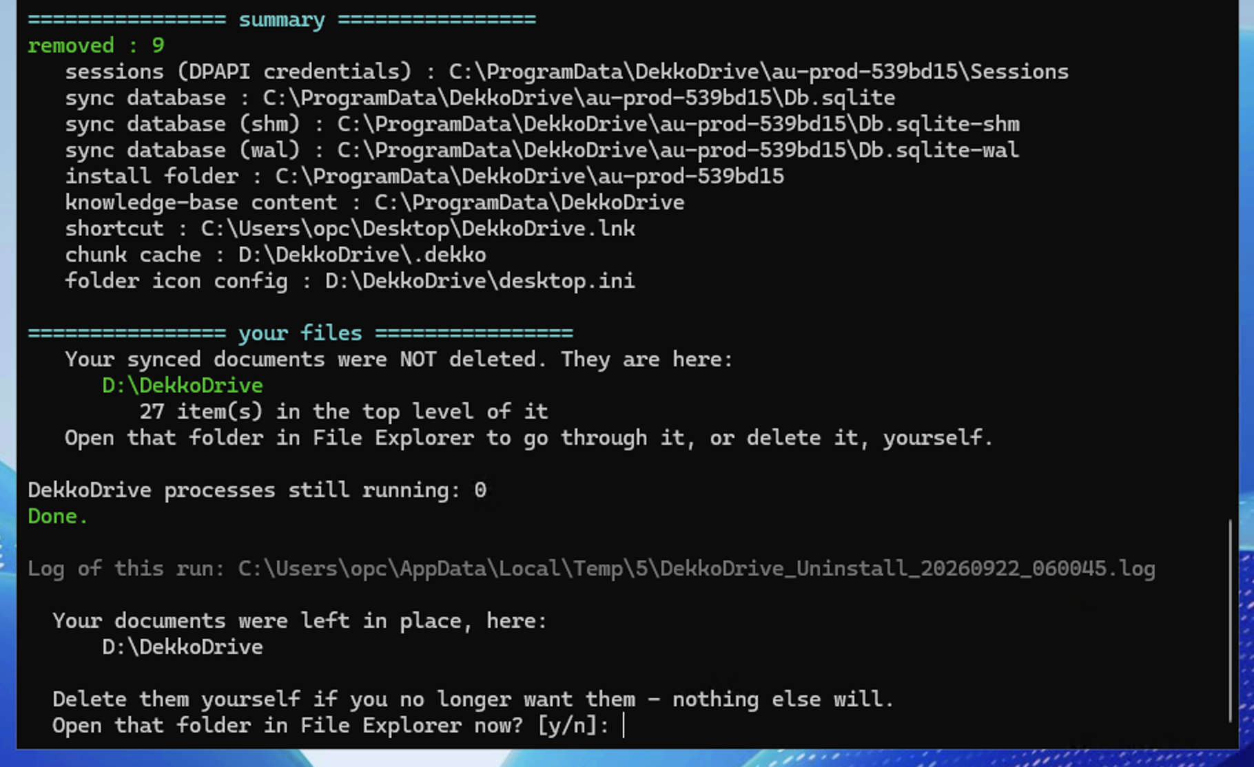 Terminal summary after uninstalling DekkoDrive, listing removed items and noting that synced documents remain in D:\\DekkoDrive, with the prompt "Open that folder in File Explorer now? \[y/n\]:".