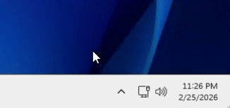 Windows taskbar system tray showing the Dekko app's icon in the hidden-icons area, with the mouse pointer hovering over the desktop above it. Wait, I need to be accurate: the image shows the taskbar's