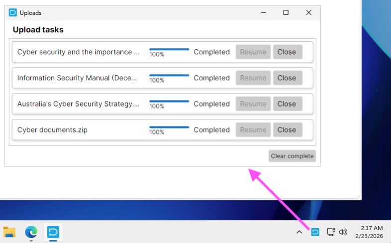 Uploads window listing four completed tasks at 100%, each with greyed-out Resume and an active Close button, plus a Clear complete button; an arrow points to the app icon in the taskbar tray.
